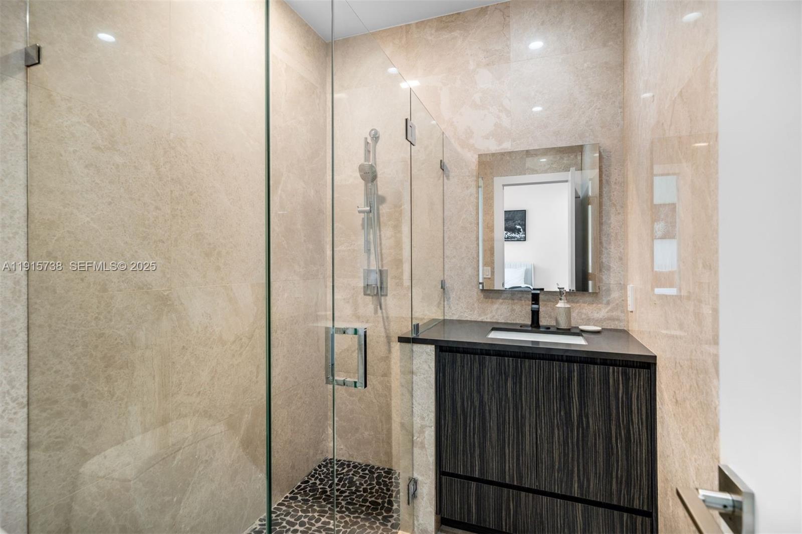 12050 Moss Ranch Road Pinecrest, FL 33156 - Photo 20 of 27 a bathroom with double sink and a mirror