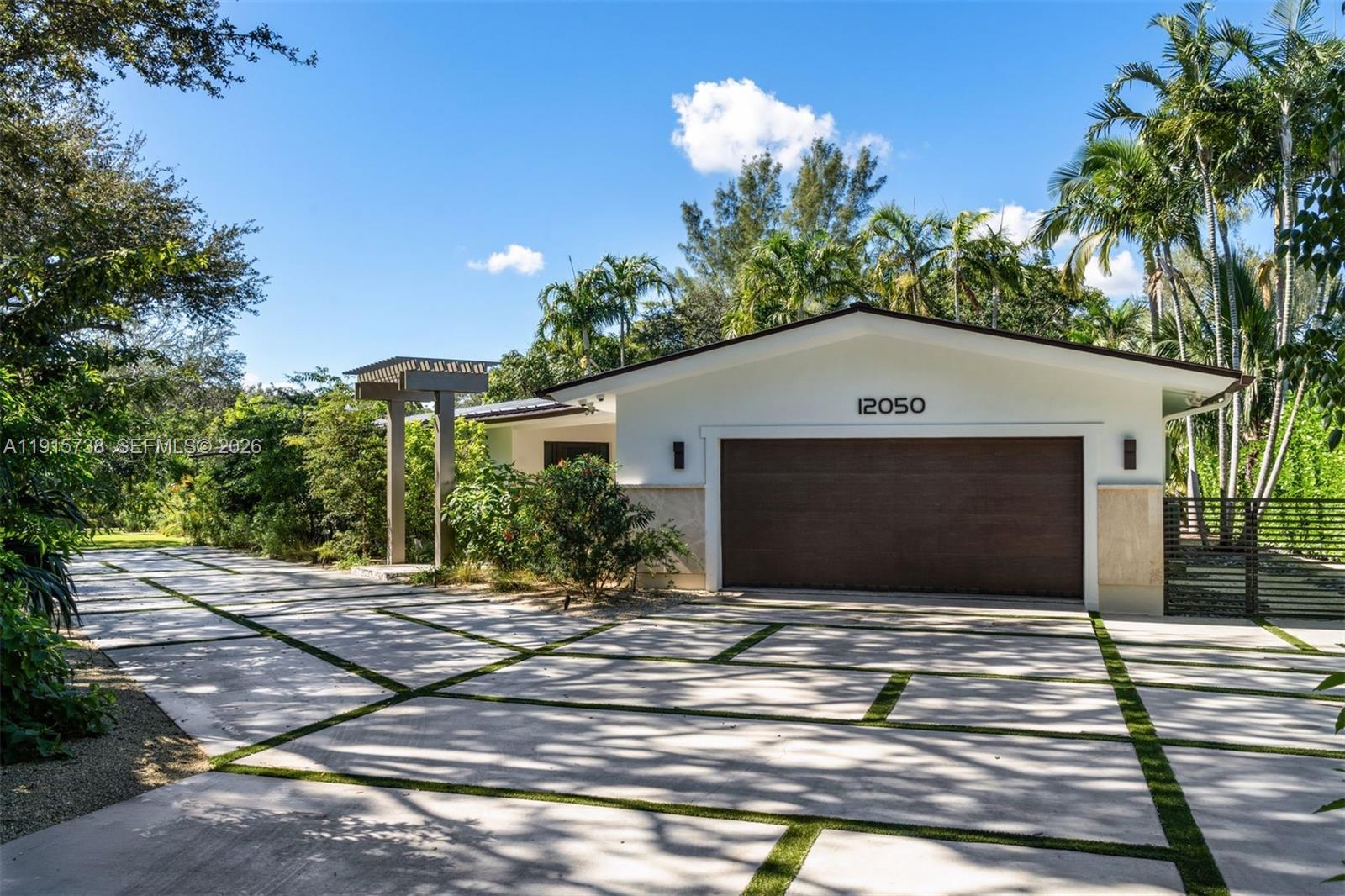 12050 Moss Ranch Road Pinecrest, FL 33156 - Photo 21 of 33 a front view of a house with a yard
