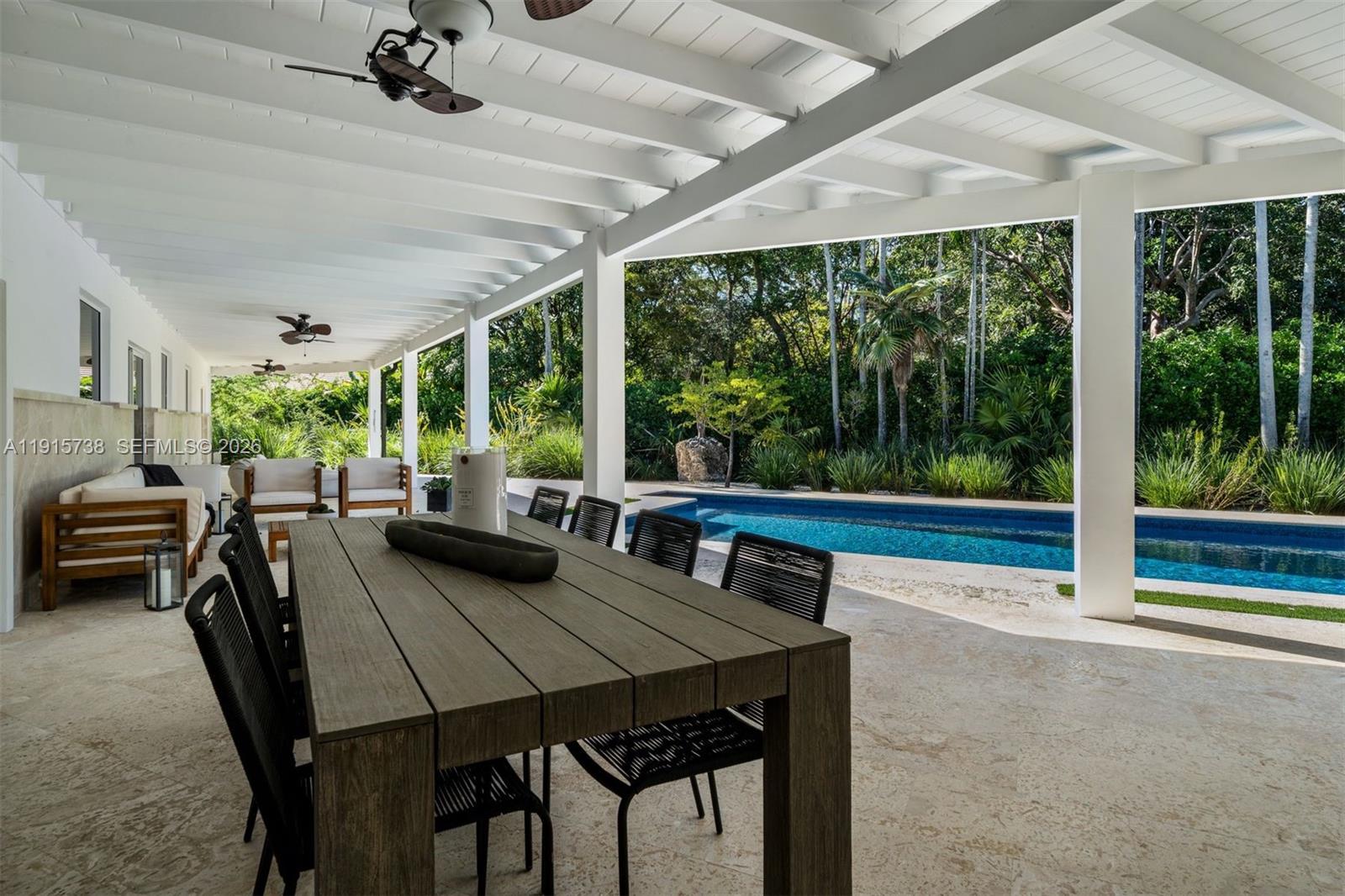 12050 Moss Ranch Road Pinecrest, FL 33156 - Photo 23 of 33 a view of a dining room with furniture window and outside view