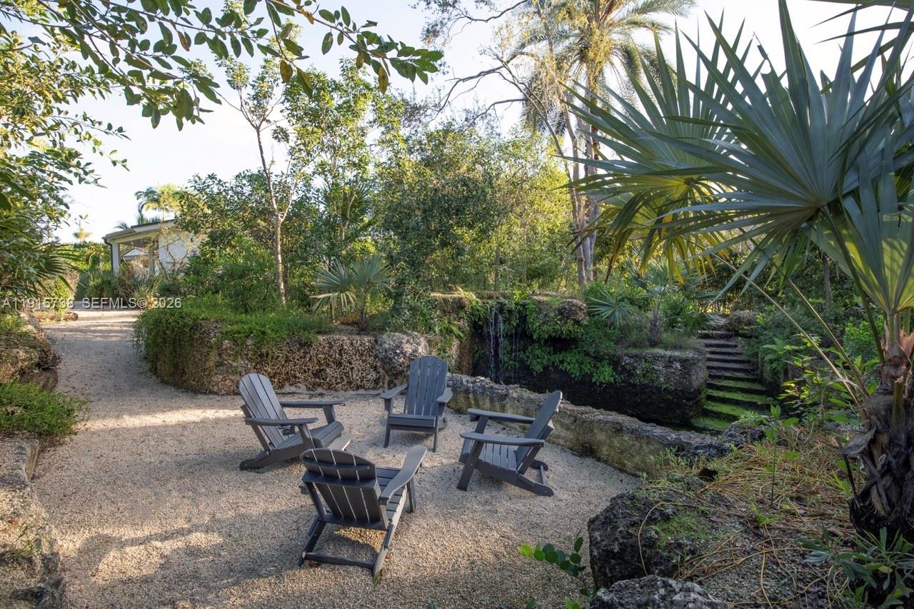 12050 Moss Ranch Road Pinecrest, FL 33156 - Photo 24 of 33 a view of a backyard with sitting area and garden