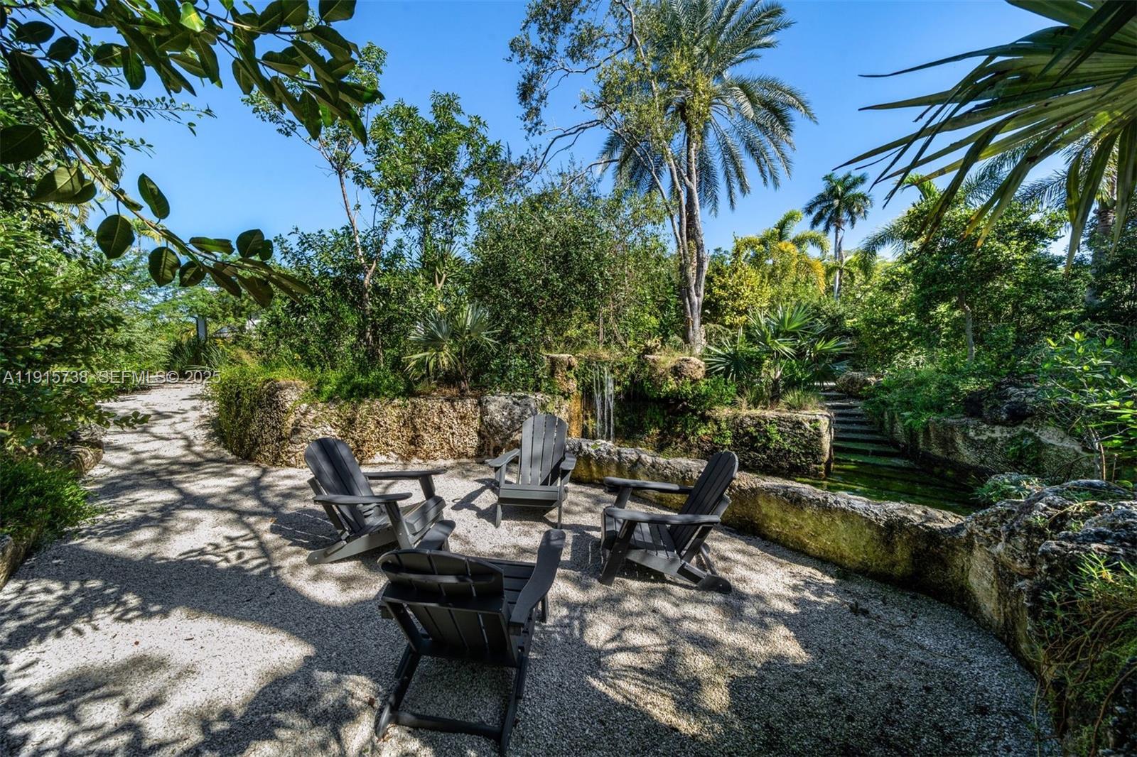 12050 Moss Ranch Road Pinecrest, FL 33156 - Photo 25 of 27 a backyard of a house with outdoor seating