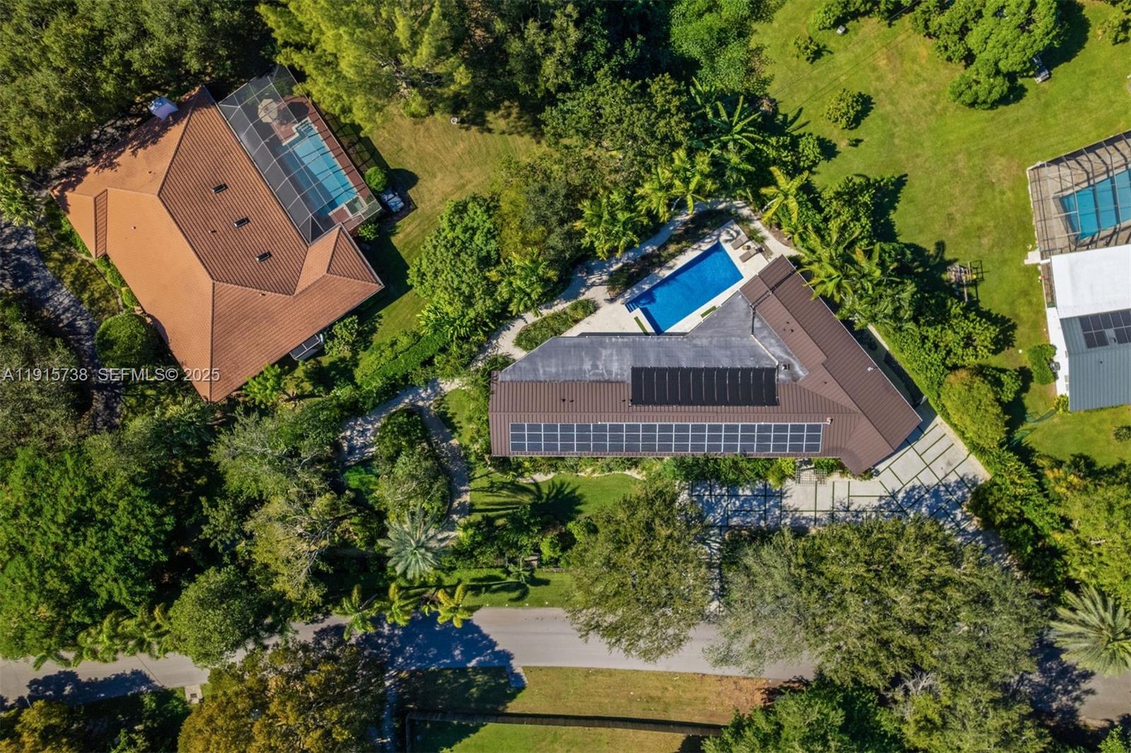 12050 Moss Ranch Road Pinecrest, FL 33156 - Photo 26 of 27 an aerial view of a house with a yard and plants
