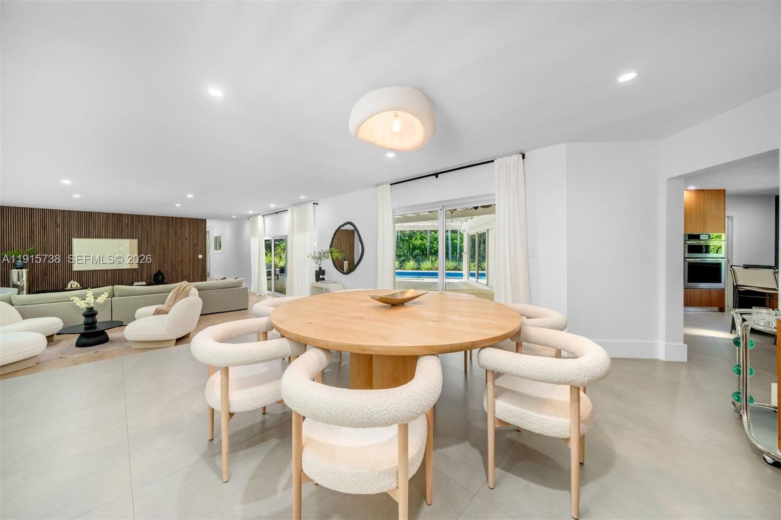 12050 Moss Ranch Road Pinecrest, FL 33156 - Photo 3 of 33 a view of a dining room with furniture and wooden floor