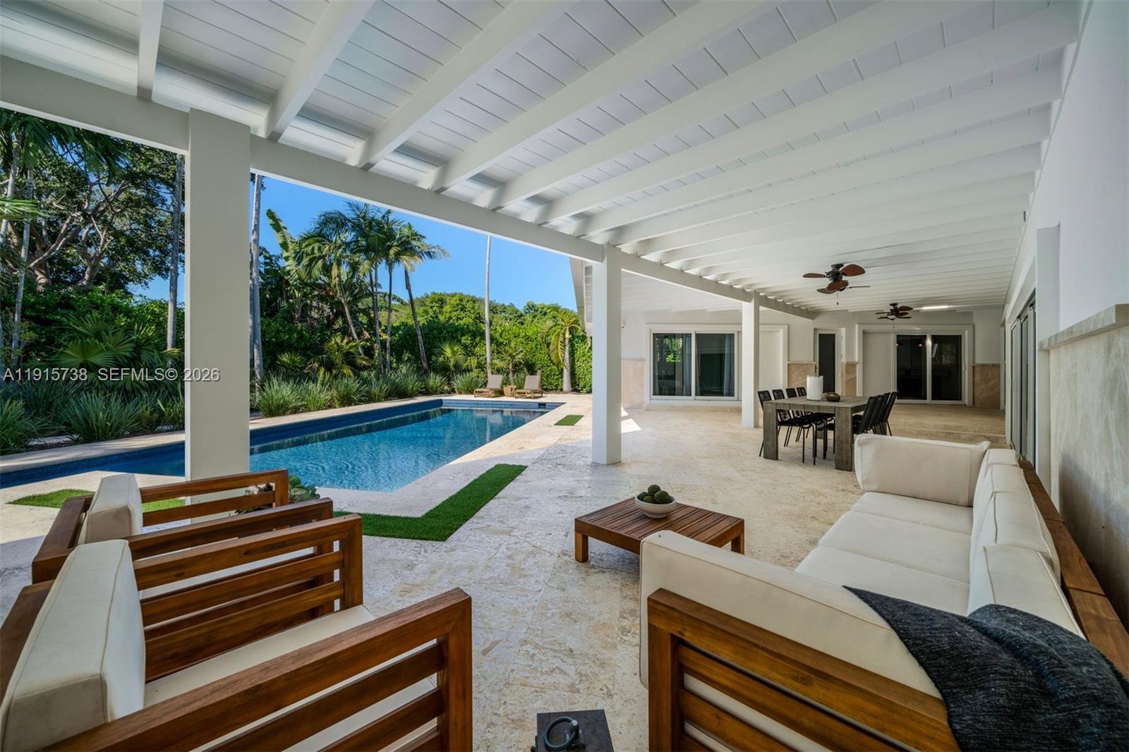 12050 Moss Ranch Road Pinecrest, FL 33156 - Photo 6 of 33 a view of a patio with couches chairs and potted plants with wooden floor