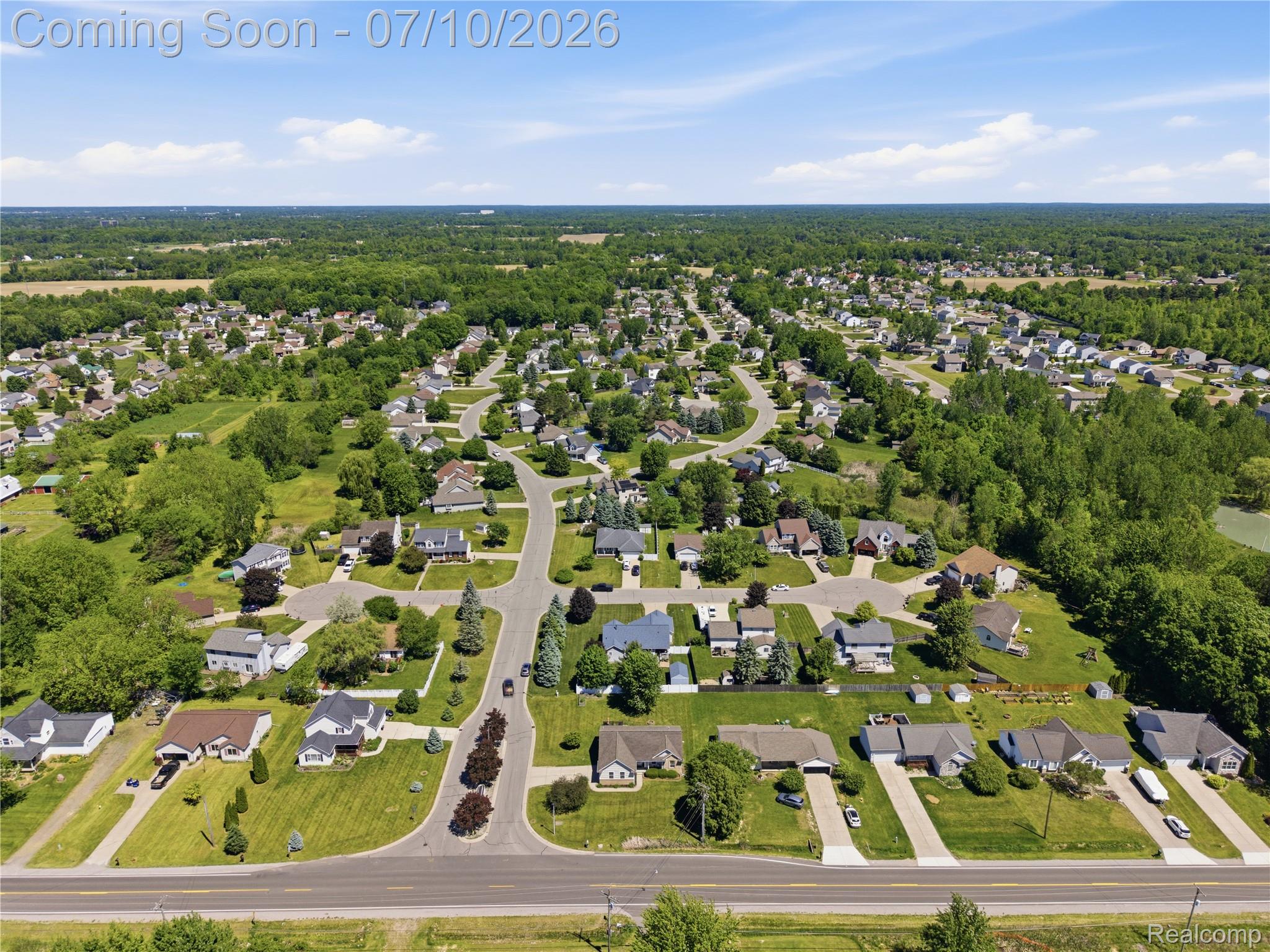 5275 East Maple Avenue Grand Blanc, MI 48439 - Photo 47 of 53 Aerial perspective showcasing a residential community with numerous single-family homes, manicured lawns, and mature trees