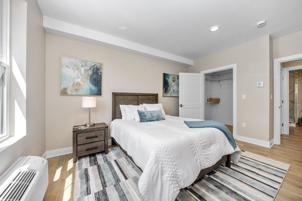 21 Totman Street, Unit MODEL2 Quincy, MA 02169 - Photo 11 of 18 a bedroom with a bed and a painting on the wall