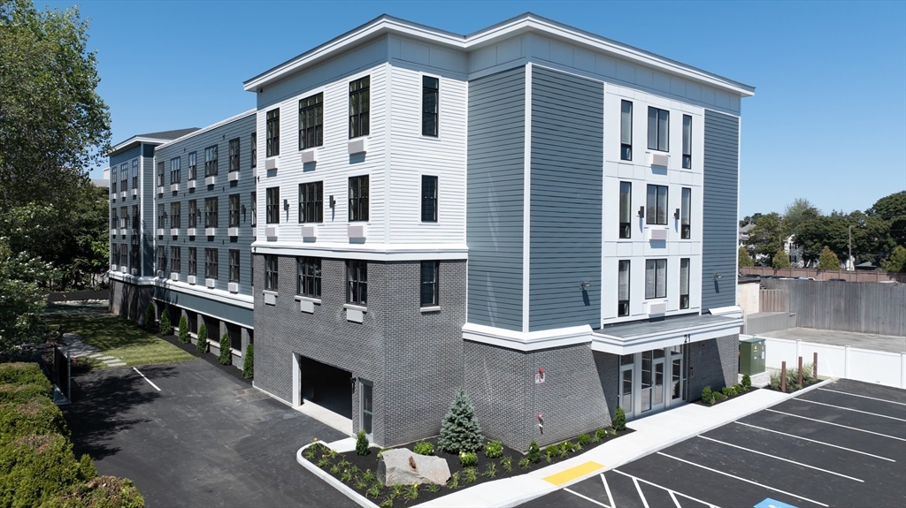 21 Totman Street, Unit MODEL2 Quincy, MA 02169 - Photo 2 of 18 a front view of a building with glass windows
