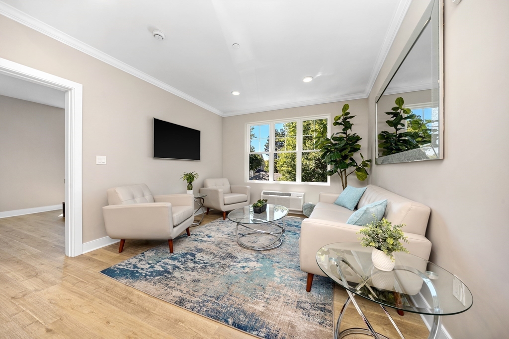 21 Totman Street, Unit MODEL2 Quincy, MA 02169 - Photo 7 of 18 a living room with furniture and a large window