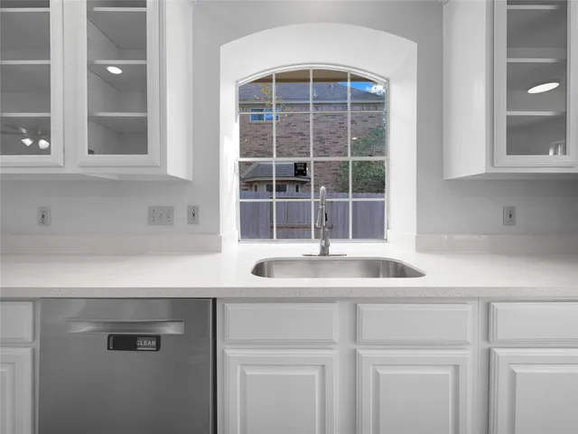 a kitchen with a sink and a window