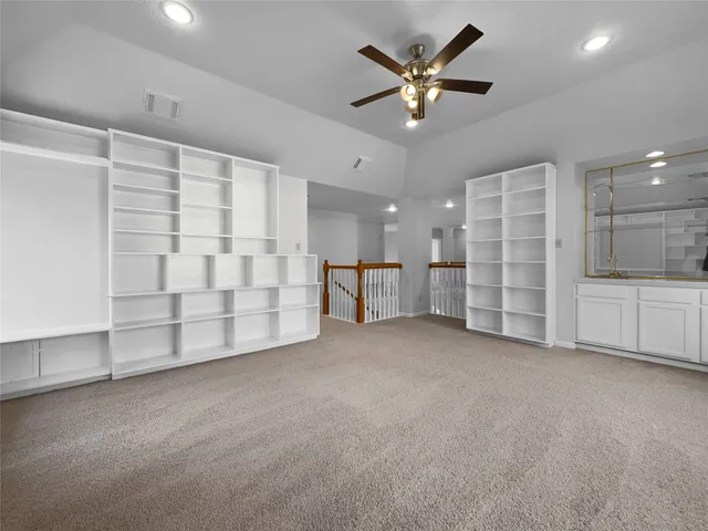 a view of an empty room with a cabinet and a window