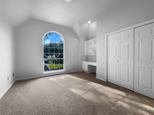 an empty room with windows lake and mountain view