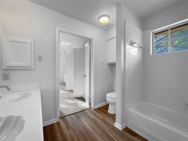 a bathroom with a sink toilet and shower