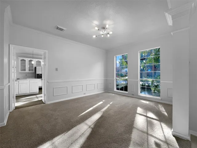 a view of a big room with windows and entryway