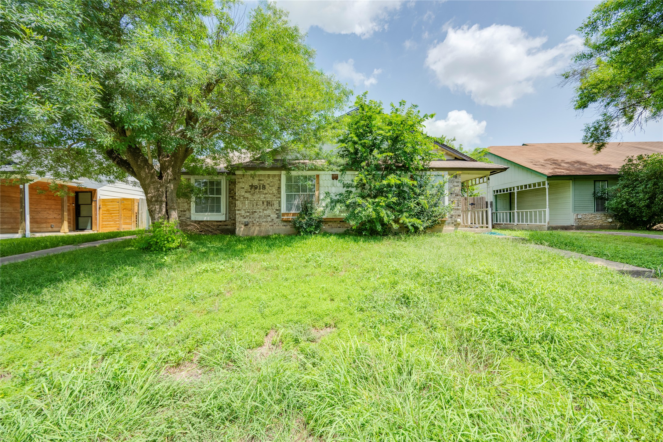 7918 West Gate Boulevard Austin, TX 78745 - Photo 1 of 31 Mature trees and a simple walkway lead to this charming residential property.