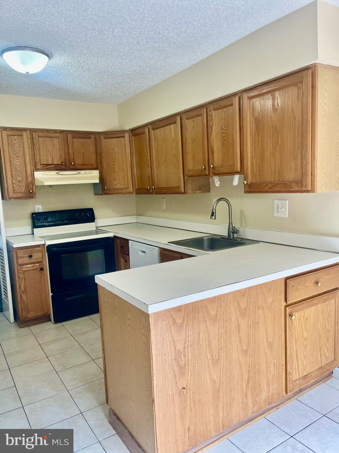 2250 Southgate Square Reston, VA 20191 - Photo 4 of 21 a kitchen with a sink a stove and cabinets