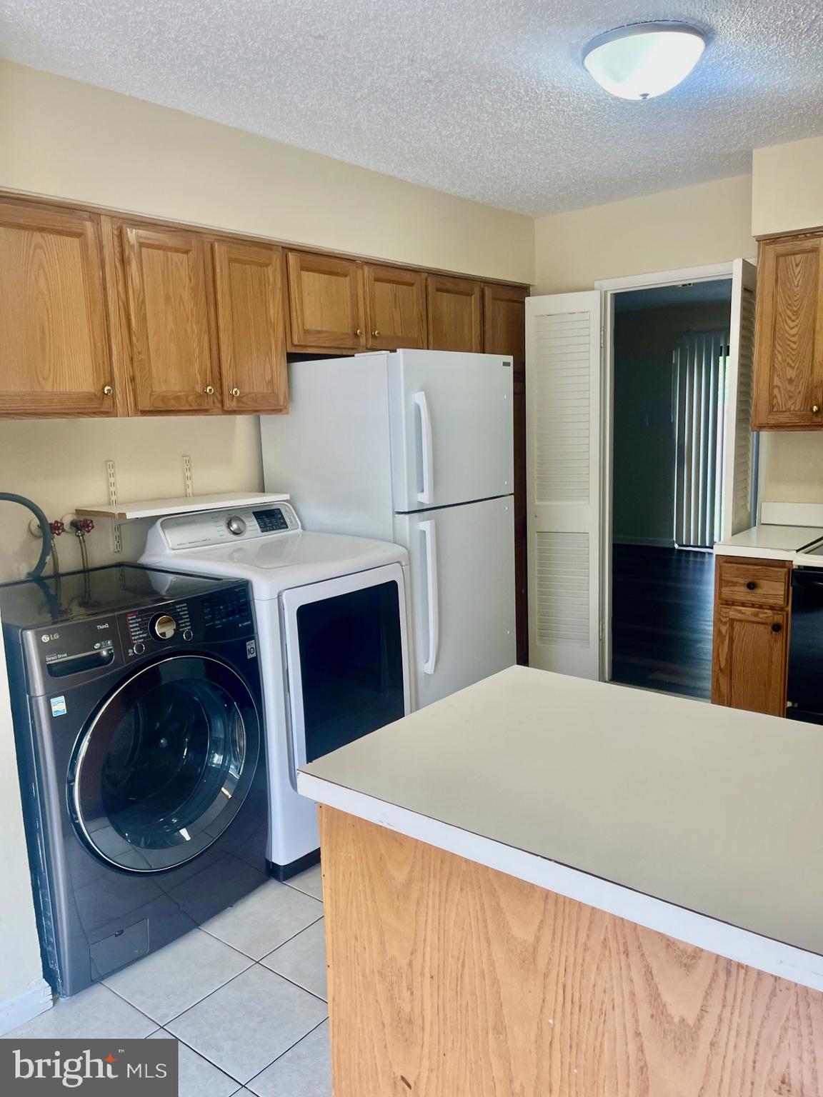 2250 Southgate Square Reston, VA 20191 - Photo 5 of 21 a kitchen with a sink a washer and dryer