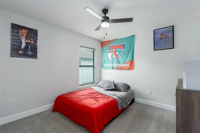 a bedroom with a bed and a painting on the wall