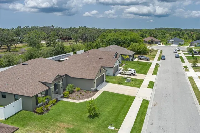 an aerial view of a house with a big yard