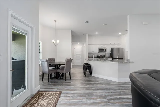 a view of a dining area with furniture and wooden floor