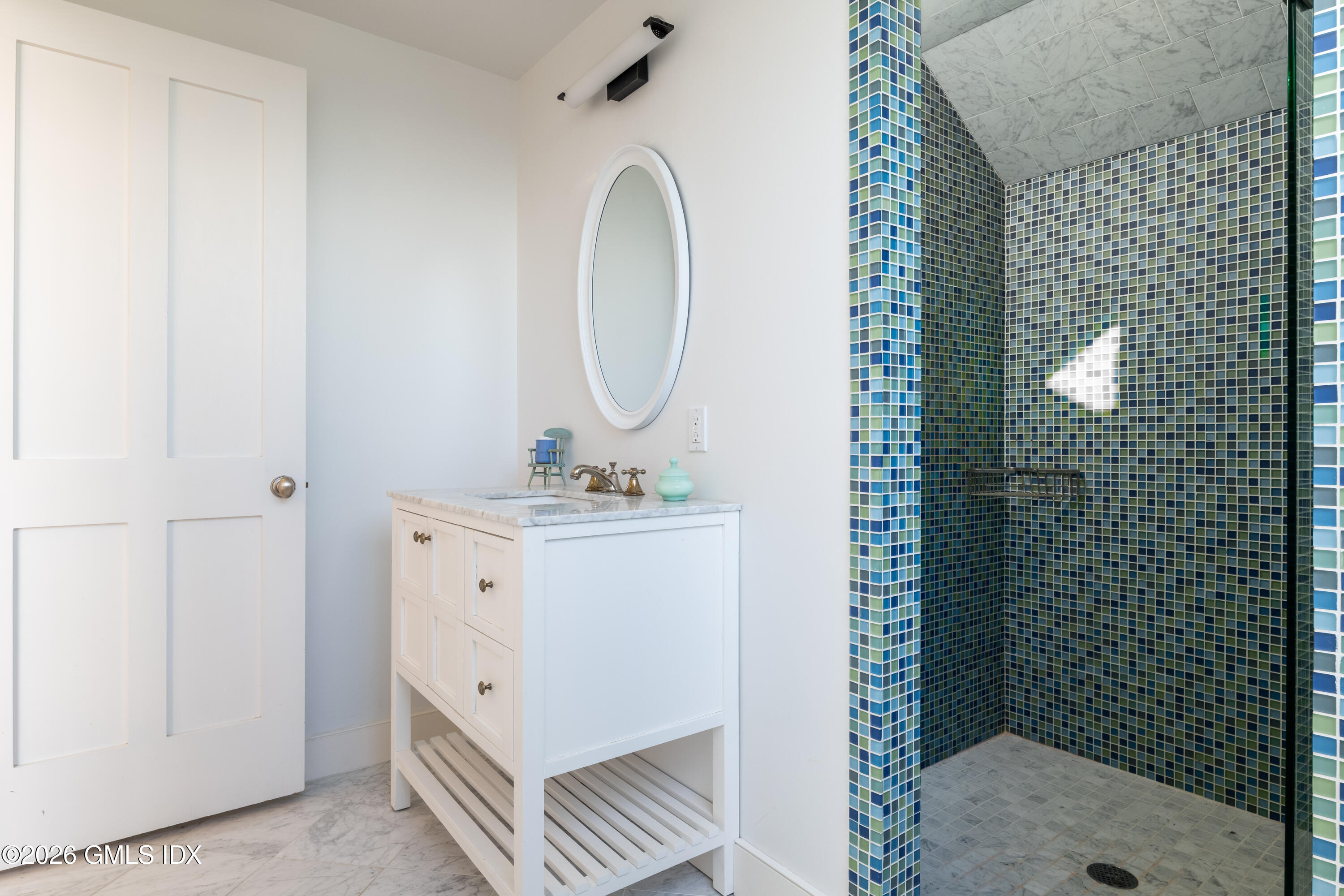 189 Shore Road Old Greenwich, CT 06870 - Photo 26 of 38 a bathroom with a sink mirror and shower