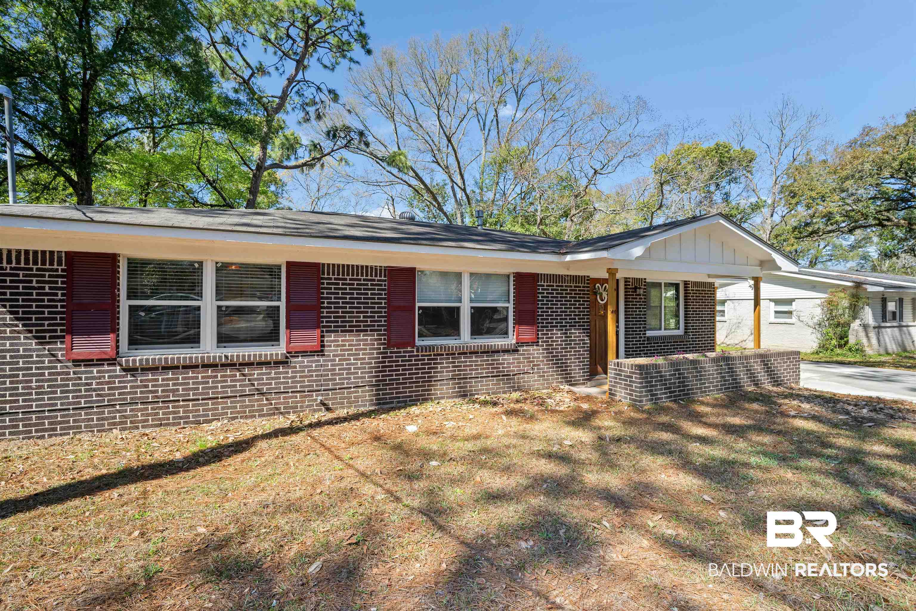 672 Tarawa Drive Mobile, AL 36609 - Photo 4 of 26 Ranch-style house featuring a front lawn, brick siding, and a porch