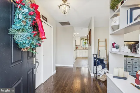 a very nice looking room with a flower pot and wooden floor