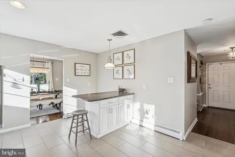 a kitchen with stainless steel appliances kitchen island granite countertop a refrigerator and a stove top oven