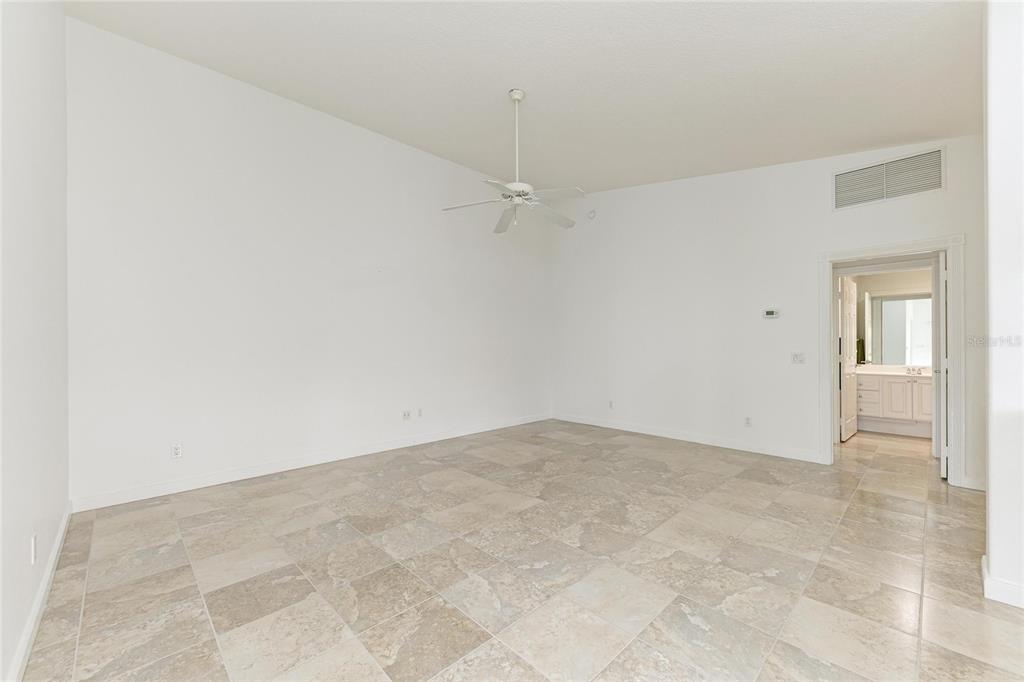 6073 Erice Street Venice, FL 34293 - Photo 12 of 71 an empty room with a ceiling fan and carpet