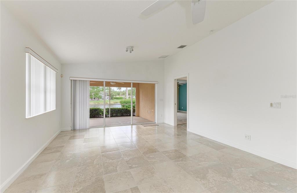 6073 Erice Street Venice, FL 34293 - Photo 18 of 71 wooden floor in an empty room with a window