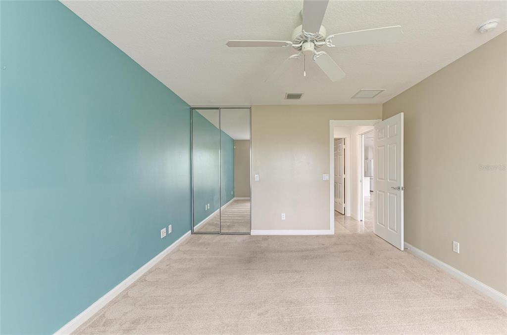 6073 Erice Street Venice, FL 34293 - Photo 27 of 71 an empty room with a ceiling fan and carpet