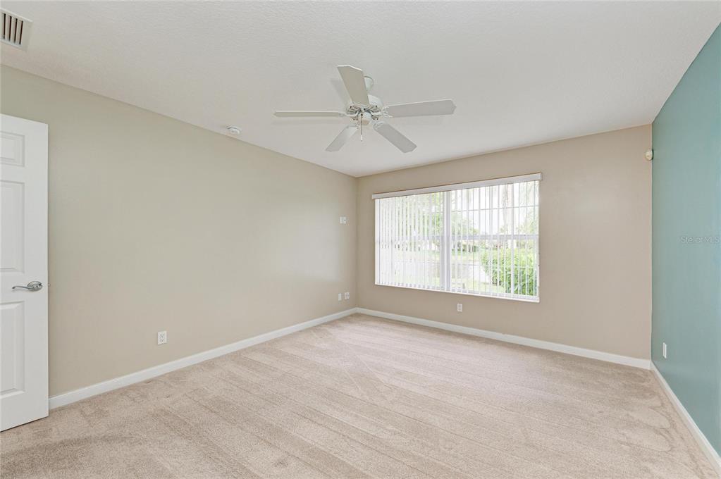 6073 Erice Street Venice, FL 34293 - Photo 28 of 71 an empty room with a window and a ceiling fan