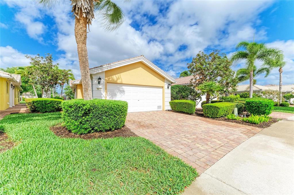 6073 Erice Street Venice, FL 34293 - Photo 3 of 71 a view of a backyard with plants and a fountain