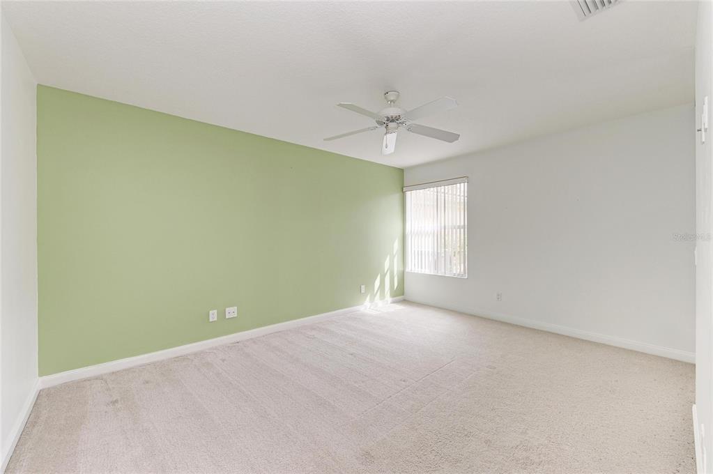 6073 Erice Street Venice, FL 34293 - Photo 32 of 71 an empty room with a window and a ceiling fan