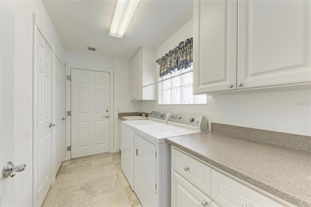 6073 Erice Street Venice, FL 34293 - Photo 36 of 71 a view of a kitchen with white cabinets