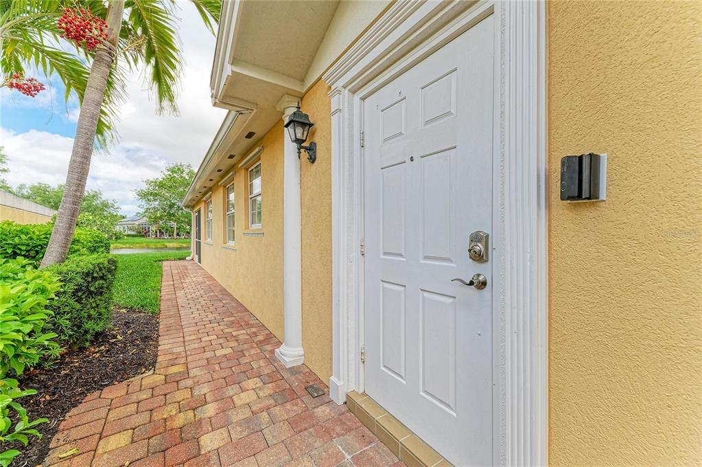 6073 Erice Street Venice, FL 34293 - Photo 4 of 71 a view of a pathway of a house with a yard