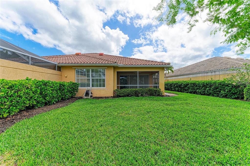 6073 Erice Street Venice, FL 34293 - Photo 49 of 71 a view of a house with a back yard