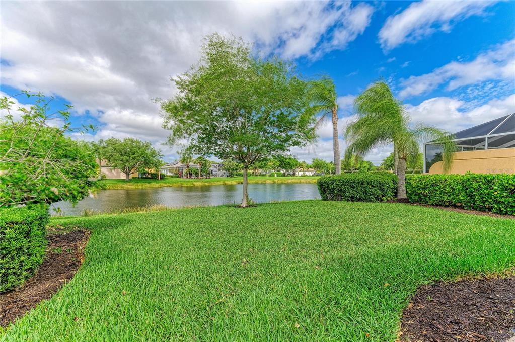 6073 Erice Street Venice, FL 34293 - Photo 50 of 71 a view of a lake with a building in the background