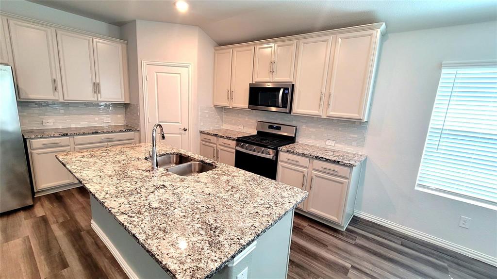 263 Sunshine Lane Lavon, TX 75166 - Photo 13 of 27 a kitchen with white cabinets and appliances
