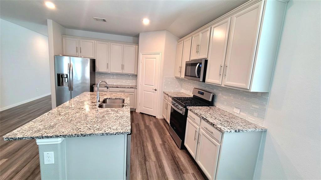 263 Sunshine Lane Lavon, TX 75166 - Photo 14 of 27 a kitchen with a sink stove and refrigerator