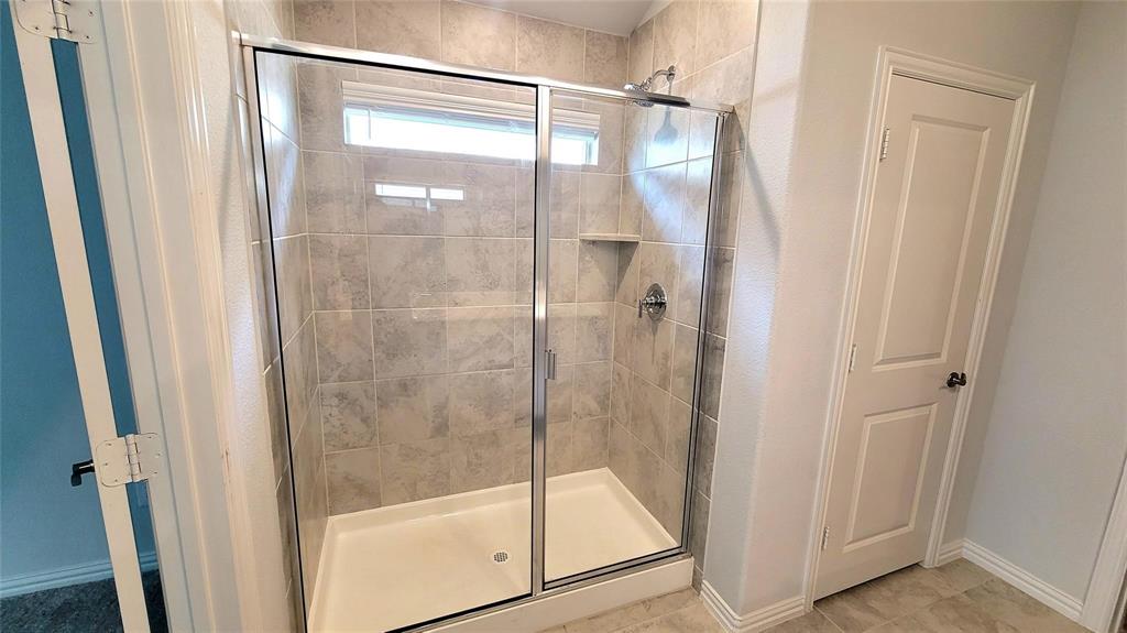 263 Sunshine Lane Lavon, TX 75166 - Photo 20 of 27 a bathroom with a glass shower door