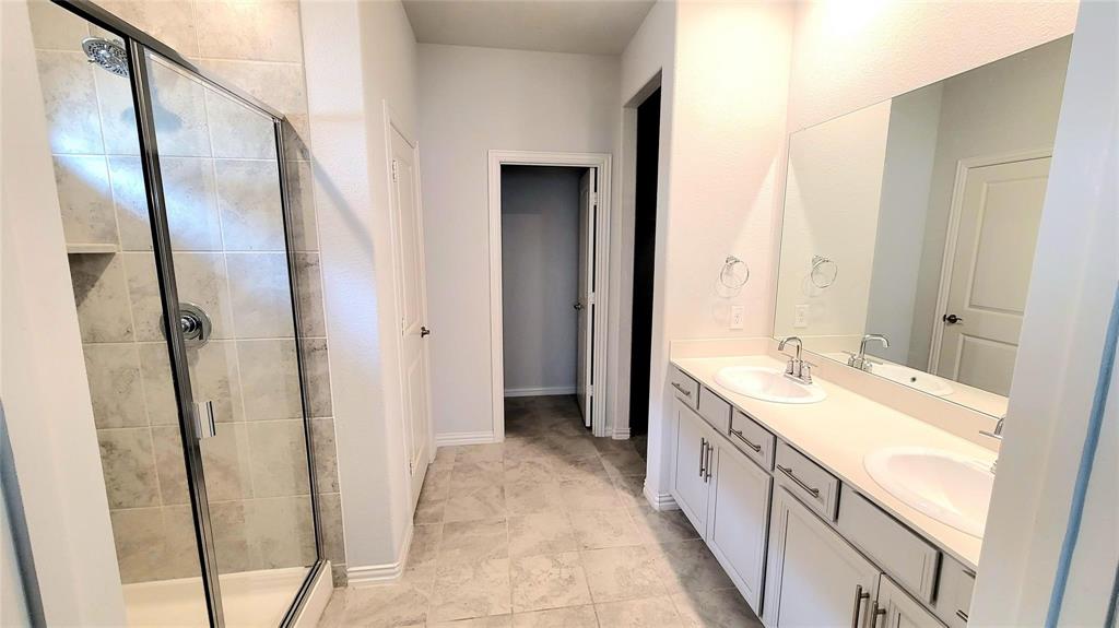 263 Sunshine Lane Lavon, TX 75166 - Photo 4 of 27 a spacious bathroom with a double vanity sink and a mirror