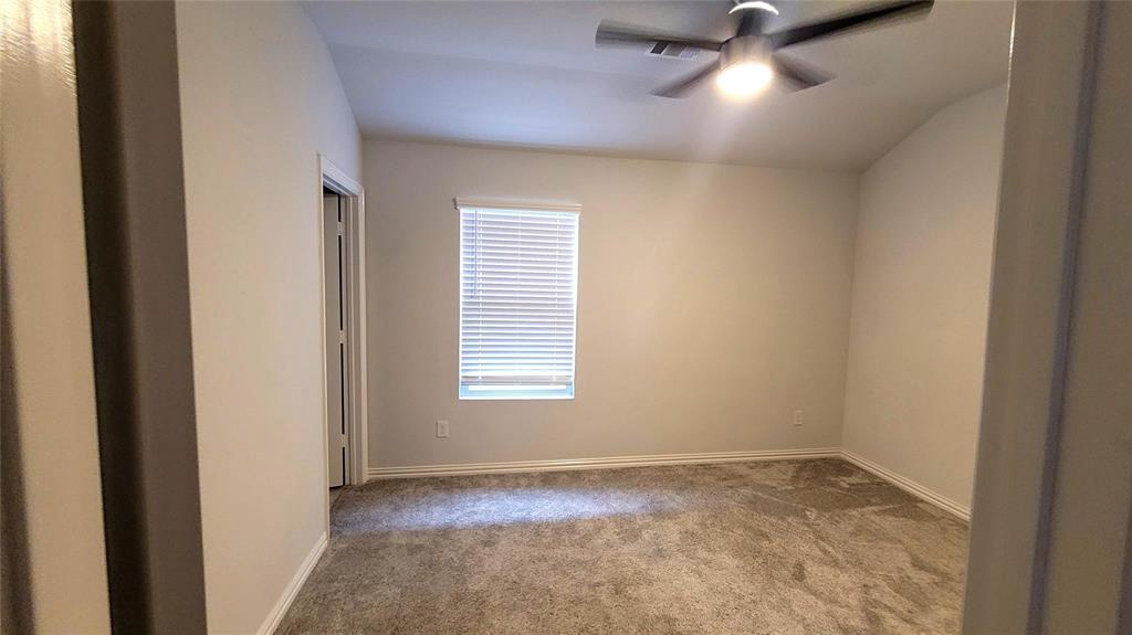 263 Sunshine Lane Lavon, TX 75166 - Photo 10 of 27 an empty room with a window and a fan