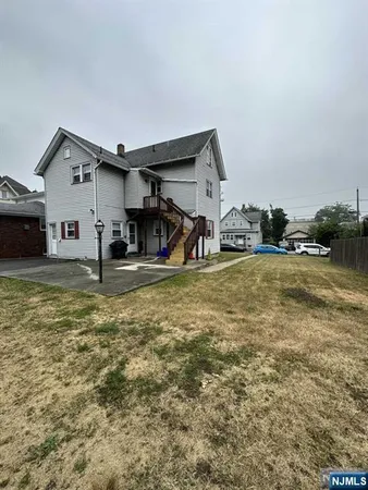 a view of a bedroom with two bed and a large window