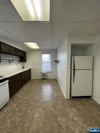 a view of a kitchen with a sink and dishwasher kitchen appliances