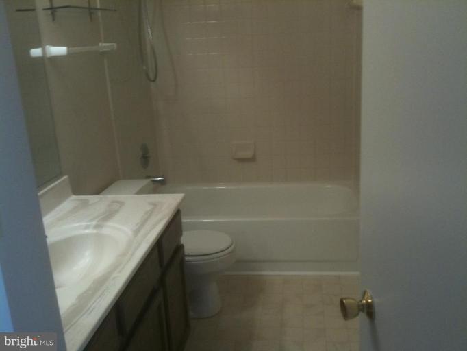 21673 Hazelnut Square, Unit 172 Sterling, VA 20164 - Photo 2 of 15 a bathroom with a sink toilet and shower