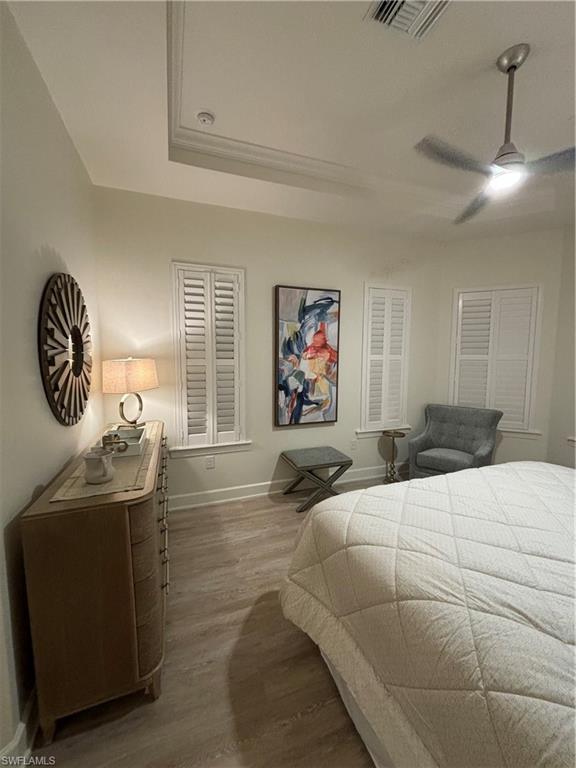 9571 Mussorie Court Naples, FL 34114 - Photo 11 of 26 a bedroom with a bed and a chandelier