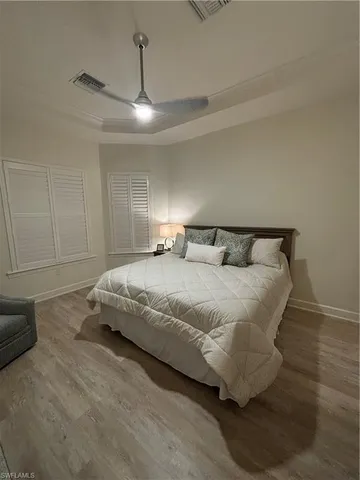 a bedroom with a bed and ceiling fan