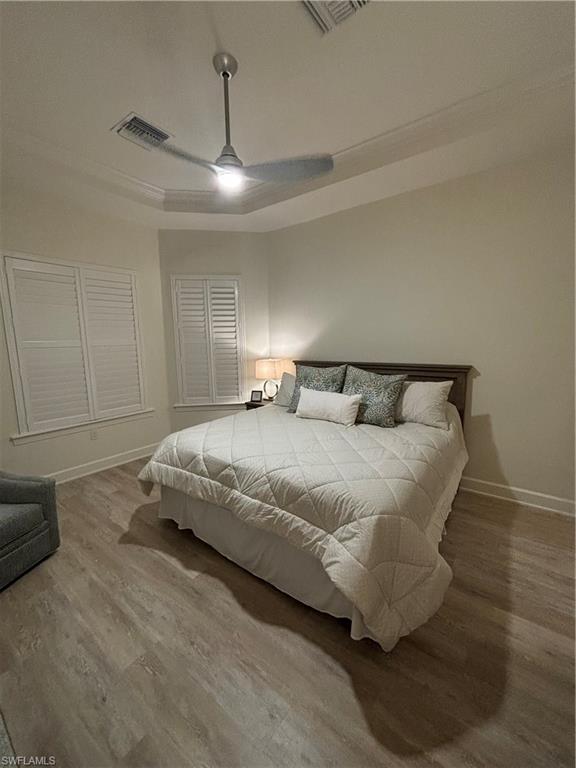 9571 Mussorie Court Naples, FL 34114 - Photo 12 of 26 a bedroom with a bed and ceiling fan