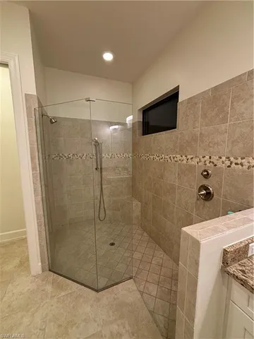 a bathroom with a shower and a sink