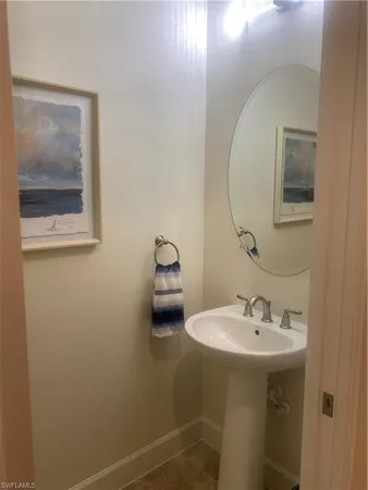 a bathroom with a sink and mirror with toilet
